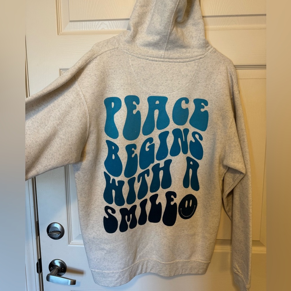 "Peace Begins With a Smile" cream hoodie size medium